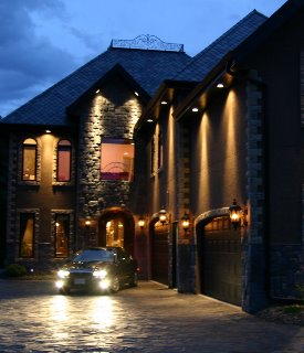 luxury rehab residence with vehicle parking on cobblestone driveway.